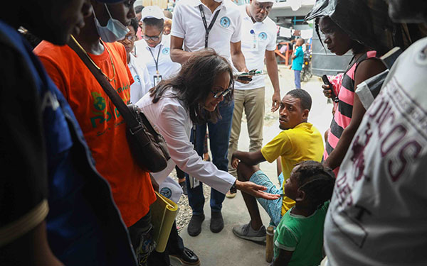 Doctor with children in the streets of Haiti