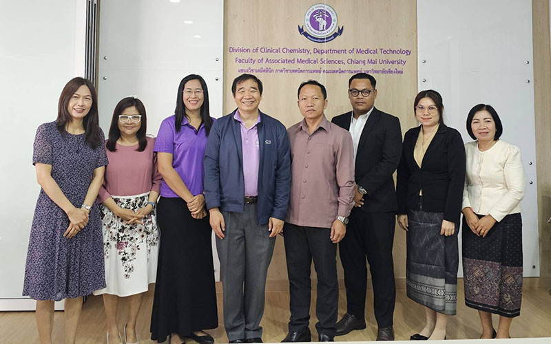 Grantees are posing under the Chiang Mai University logo, in one of the University classroom