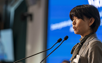 Zoom in on Yukiko Nakatani, at the lectern microphone